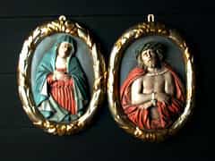 Paar geschnitzte Reliefbildnisse von Jesus und Maria im ovalen Lorbeerkranz-Rahmen