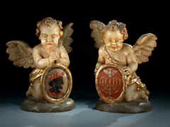 Paar geschnitzte knieende Engel, jeweils auf rundem Rasensockel.