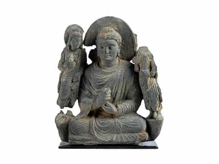 Steinfigur eines im Lotussitz thronenden Buddhas mit seitlichen Begleitfiguren