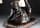 Detailabbildung: Italienischer Hocker in figürlicher Gestaltung eines in akrobatischer Haltung sitzenden Mohren auf einem Kissen